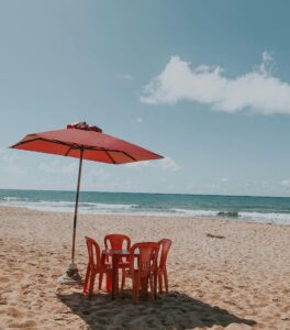 beach chairs set up under umbrella