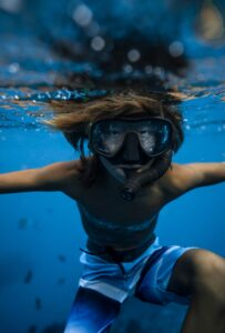 kid enjoying hawaii underwater